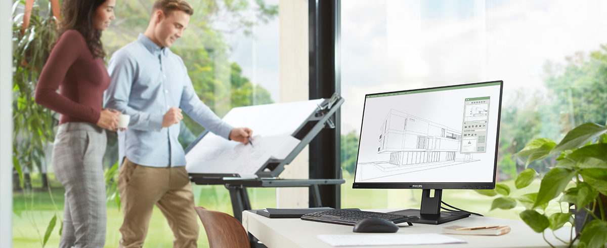 Люди насолоджуються робочим місцем з екологічними моніторами Philips.
